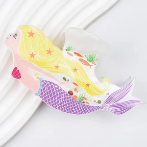 Detailed macro view of an acrylic mermaid hair claw clip with colorful marine patterns