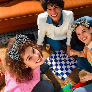 Close-up of leopard and zebra print oversized bow headbands worn in a social setting