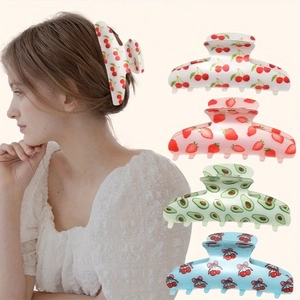 Detail of large hair claws with fruit prints shown on a model and in multiple styles