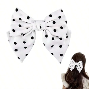 Detailed view of polka dot bow hair clip and a side view of hair styling usage