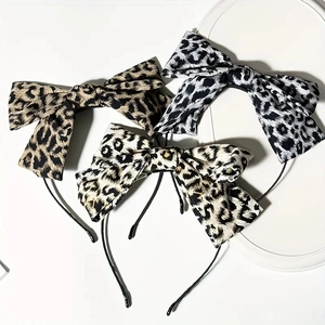Three-piece set of elegant leopard print bow headbands in brown, grey, and cream white
