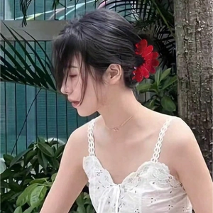 Elegant red flower acetate hair claw clip worn by a model in a natural outdoor setting