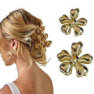 Detail of metallic flower hair claw clips and heart earrings set for elegant styling