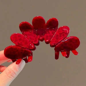 Elegant red acetate flower claw clip with textured petals for stylish high ponytails