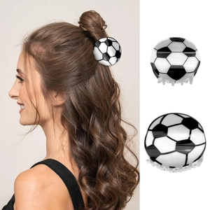 Close-up of a glossy black and white soccer ball hair claw clip for a ponytail