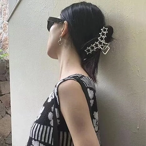 Chic silver hollow star metal hair claw clip shown on a model for daily hairstyling