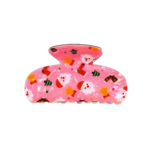 Detail einer rosa Haarklammer aus Acetat mit Motiven von Weihnachtsmann und Tannenbaum
