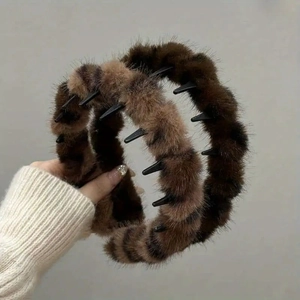Detail shot of plush leopard print headbands with internal plastic teeth for a secure grip