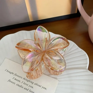 Pince à cheveux fleur de frangipanier orange irisé avec finition brillante et ressort