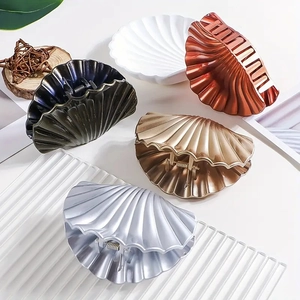 Five assorted shell-shaped hair claws in metallic finishes for elegant hair styling