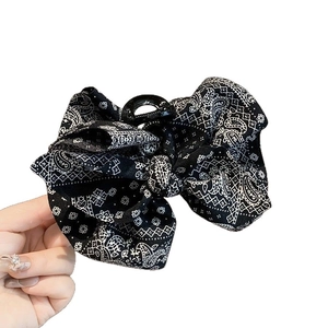 Elegant black and white paisley bow hair claw clip for women's stylish hair styling