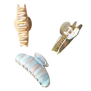 Three large matte marble pattern shark hair clips in assorted gradient pastel colors