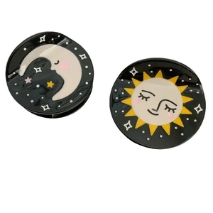 Black round hair claw clips featuring celestial sun and moon patterns with starry accents