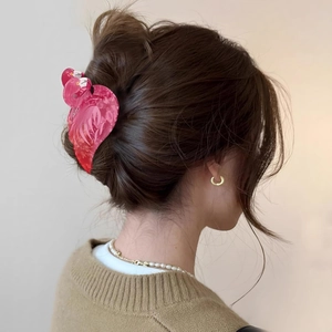 Pink flamingo hair claw clip detail on hair bun with a marbled acetate texture finish
