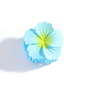 Close-up of elegant light blue and yellow gradient flower hair claw clip with matte finish