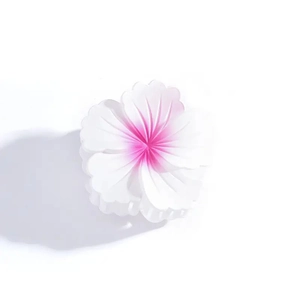 Detailed close-up of a pink gradient hibiscus flower hair claw clip on white background