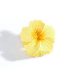 Detailed macro view of yellow matte floral hair claw clip with orange gradient petals