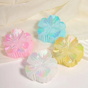 Set of four colorful shell-shaped hair claw clips with iridescent rainbow laser coating