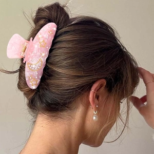 Elegant pink marble acrylic hair claw clip with gold stars and rhinestones for women