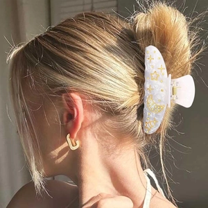 Elegant acrylic hair claw clip with gold star and moon patterns on pearlescent white