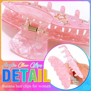 Detailed macro view of pink acrylic hair claw clip with golden star and rhinestone accents
