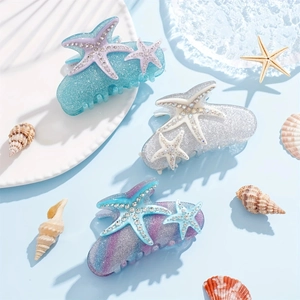 Three starfish claw clips with glitter finish and rhinestones for beach hair styling