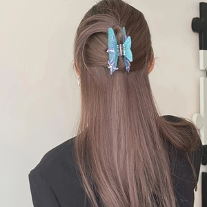 Detailed view of bohemian starfish rhinestone hair claw clip on a half-up hairstyle
