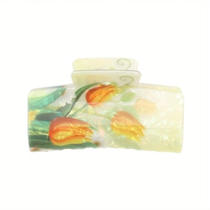 Detail showing tulip pattern on a pearlescent yellow hair claw clip with spring hinge