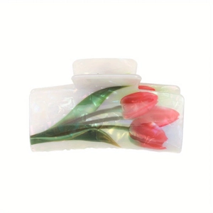 Detail of white acetate hair claw clip with red tulip patterns and mother-of-pearl finish