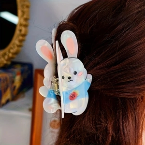 Detail view of cute rabbit hair claw clip with carrot design on brunette hair