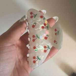 Detail of large hair claw clip with sweet cherry print and pearlescent resin finish