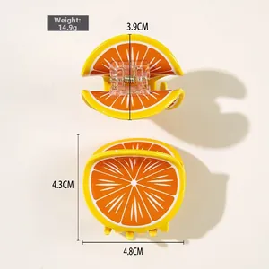 Détail de la pince à cheveux orange indiquant le poids de 14,9 g et les dimensions