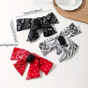 Three-piece paisley bow hair claw clip set in black, white, and red fabric finish