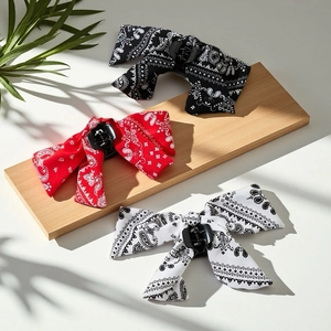Three paisley print bow hair clips in black, red, and white for elegant hairstyles