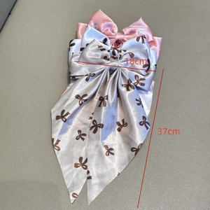 Sweet satin bow hair clips in pink and grey with ribbon tails and small floral patterns