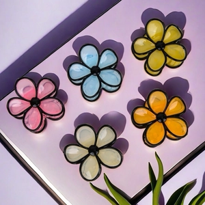 Five colorful flower hair claws in jelly tones with elegant black outlines and dark centers