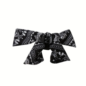 Detail of paisley print bow hair claw clip with elegant long ribbons on white backdrop