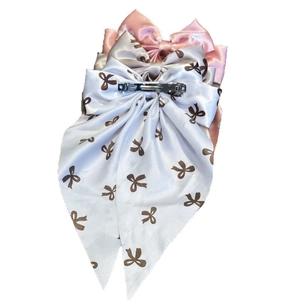 Detailed back view of satin bow hair clips showing durable silver metal spring fasteners