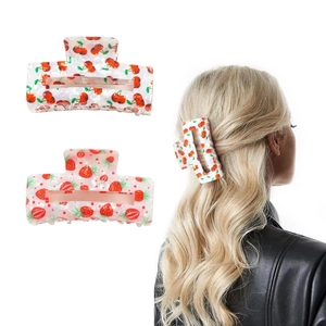 Square hair claws with cherry and strawberry prints on white background and model display