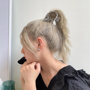 Detail of silver hollow skull hair claw clip on ponytail for punk style hair look
