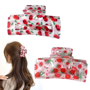 Square hair claw clips with cherry and strawberry fruit prints on a white background