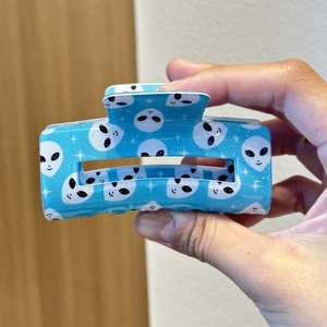 Blue rectangle hair claw clip with alien head prints and silver glitter finish