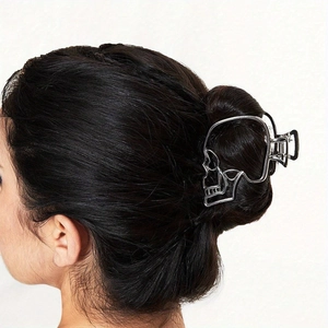 Gothic silver metal skull hair claw clip shown on back view of dark hair hairstyle
