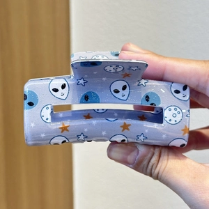 Sparkly lavender square hair claw clip featuring alien and space planet patterns