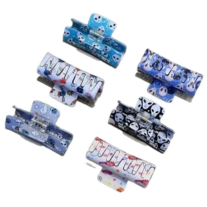 Set of 6 alien and space themed hair claws with planets and rocket prints for parties
