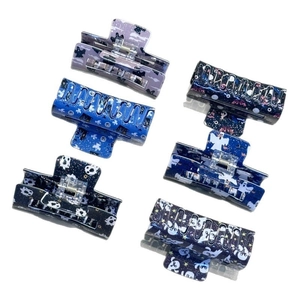 Set of 6 dark ghost hair claws with Halloween motifs like bats and stars on white background