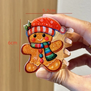 Detail of gingerbread man hair claw clip with size dimensions 6cm and 5.2cm for Christmas