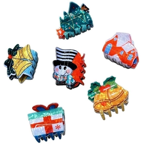 Set of six Christmas hair claws featuring Santa, snowman, and tree designs on white base