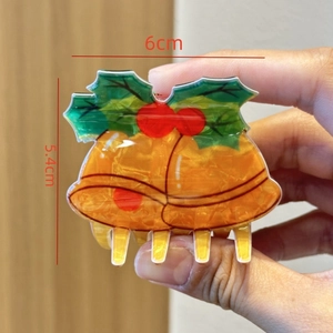 Detail view of a 6cm acetate Christmas bell hair claw clip with size measurements
