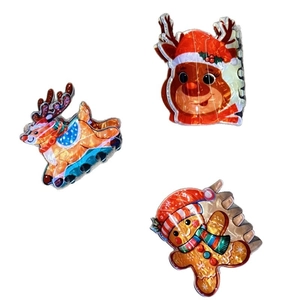 Cartoon Christmas hair claws featuring reindeer and gingerbread man acrylic designs